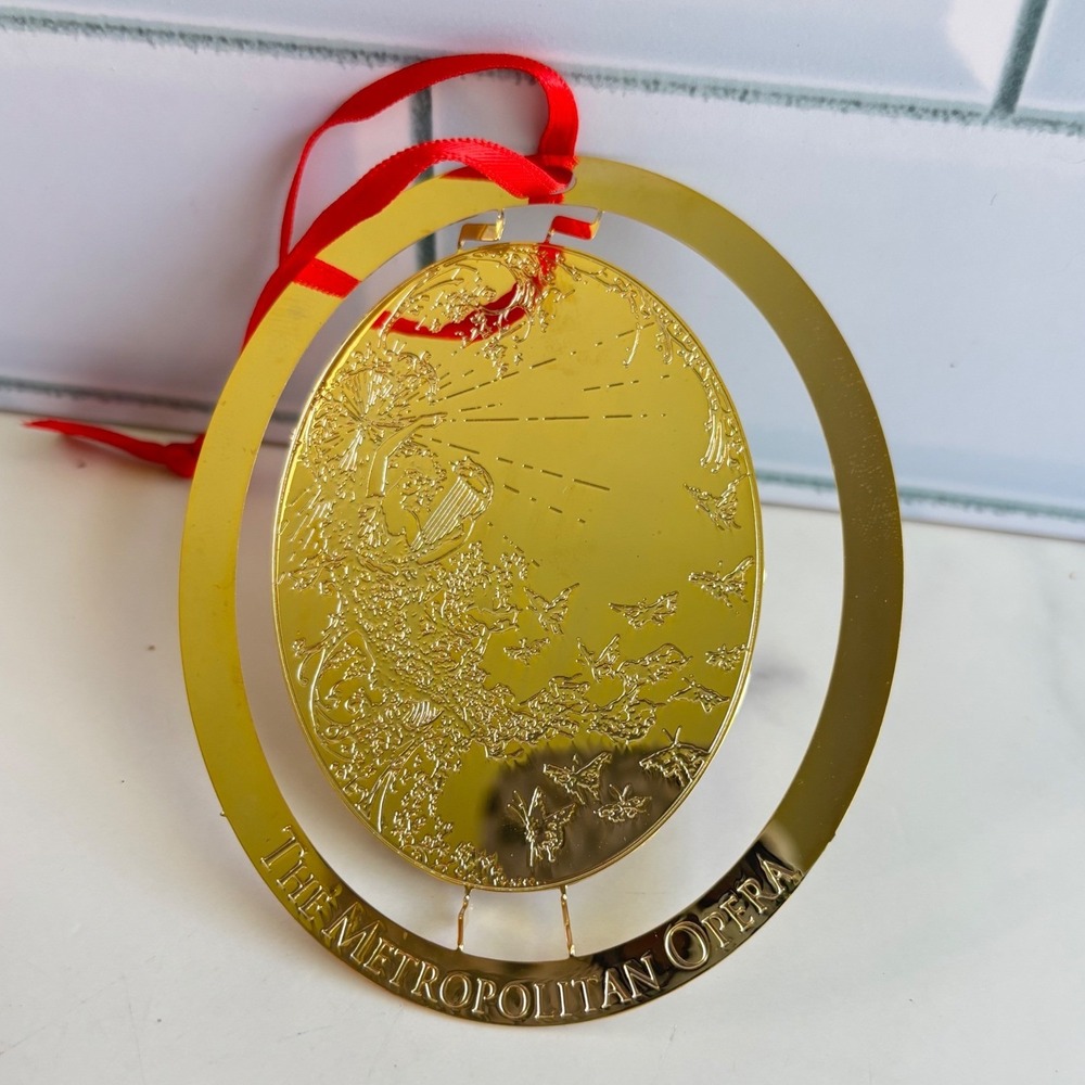 The Metropolitan Opera Gold Tone Etched Spinning Oval Christmas Ornament